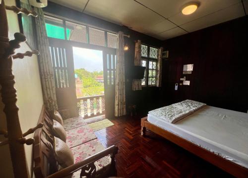 a bedroom with a bed and a large window at Ban Heng in Phra Nakhon Si Ayutthaya
