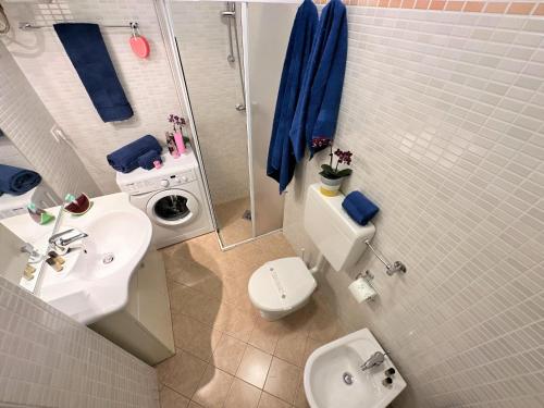 a bathroom with a sink and a toilet and a shower at Residence Oceanico in Lignano Sabbiadoro