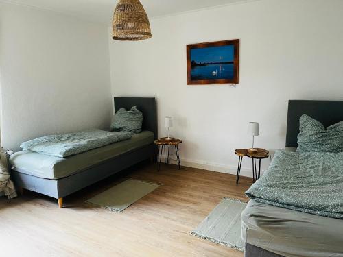 a bedroom with a bed and a couch and two tables at Ferienwohnung Peters (EG) in Hünfeld