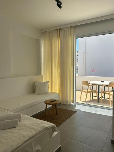 a hotel room with a bed and a table and a balcony at Anais Bay Hotel in Protaras