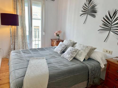 a bedroom with a large bed with pillows on it at Con Encanto in San Sebastián