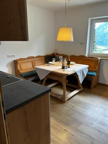 a living room with a table and a couch at Ferienwohnung Bärenblick Achensee in Eben am Achensee