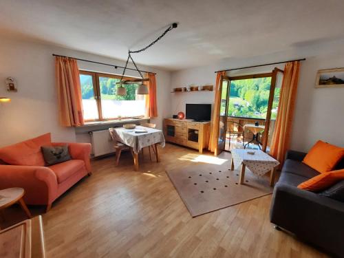 a living room with a couch and a table at Haus Angerbichl in Ramsau