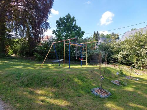 a playground in a yard with a swing set at Gasthof Oberschmiede in Auf der Wiese