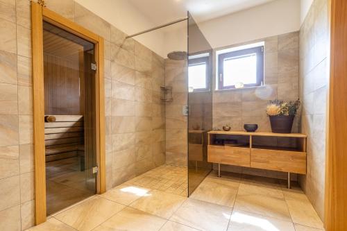 a bathroom with a shower with a glass door at Black Swan in Brocēni