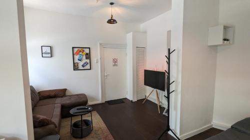 ein Wohnzimmer mit einem Sofa und einem Flachbild-TV in der Unterkunft Deine Unterkunft in zentraler Lage in Hamburg Altona in Hamburg