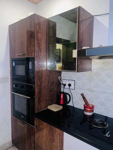 a kitchen with a counter with a microwave and a stove at Blue sky Apartment in Nathia Gali