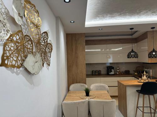 a kitchen with a table and butterflies on the wall at Luxury apartment Old town Novi Pazar in Novi Pazar