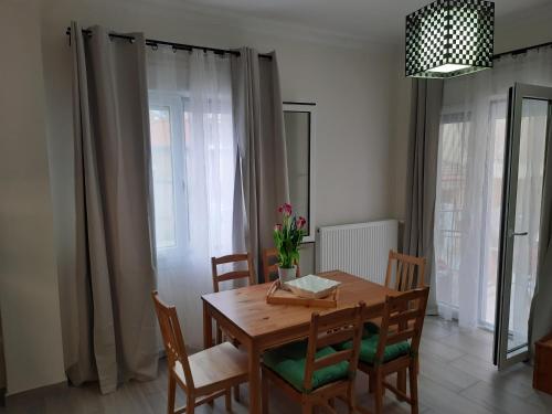 a dining room with a wooden table and chairs at Akis Place in Ioannina