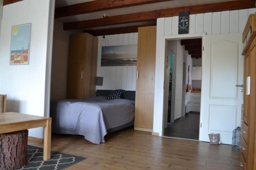 a bedroom with a bed and an open doorway at Ferienwohnung Skagen in Westerdeichstrich