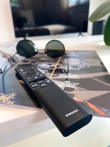 a remote control with sunglasses on top of a table at Penthouse - Zentral und Genial in Passau