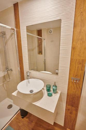 a bathroom with a sink and a mirror at 631 PARAISO MASPALOMAS in Maspalomas