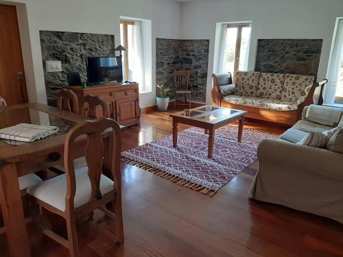 a living room with a couch and a coffee table at Casa da Ribeira in São Vicente