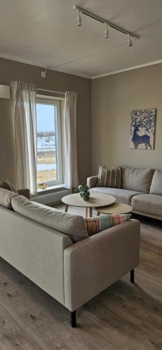 a living room with a couch and a table at Kirkenes Interlake in Kirkenes