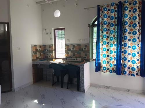 a kitchen with a table with chairs and a mirror at Golden Oak Villa in Mussoorie