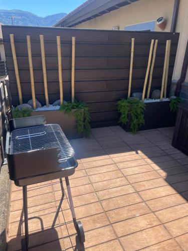 a black bench sitting on a patio with plants at Casa Mati in Sorripas
