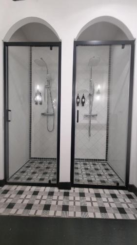 a bathroom with a shower with two glass doors at Appartement neuf avec garage + fibre in Blanzac
