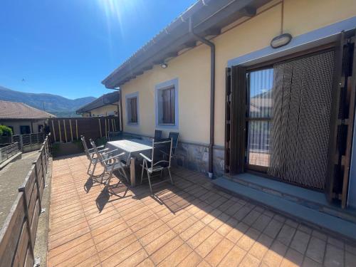 a deck with a table and chairs on a house at Casa Mati in Sorripas