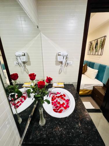 a bathroom with a toilet and flowers in a mirror at Khách Sạn 239 in Hanoi