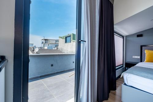 a bedroom with a bed and a large window at The Row Taksim Hotel in Istanbul