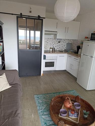 une cuisine avec un bol de nourriture sur le sol dans l'établissement duplex avec vue mer et coucher de soleil radieux, à Six-Fours-les-Plages