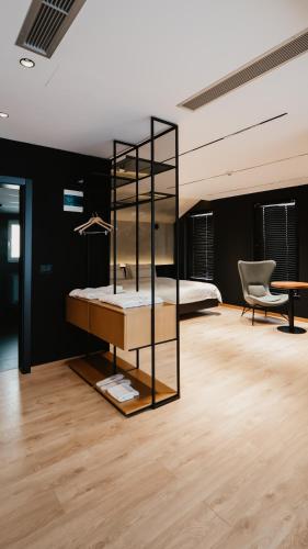 a bedroom with a bed and a mirror at BAZ'HUR Boutique Hotel in Kukës