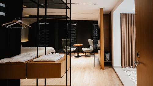 a bedroom with a bunk bed and a table and chairs at BAZ'HUR Boutique Hotel in Kukës