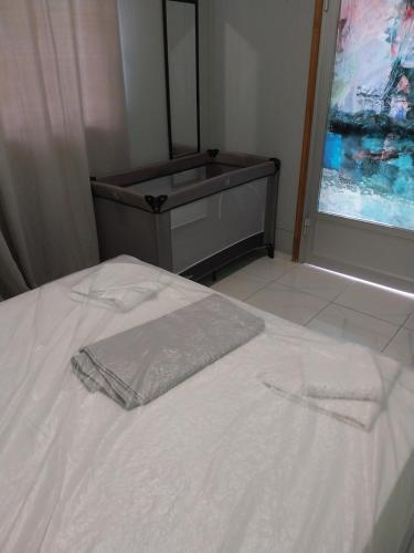 a white bed with a mirror and a sink at Villa Artzie. Έξοχικο με τεράστιο εξωτερικό χώρο. in Nea Kallikrateia