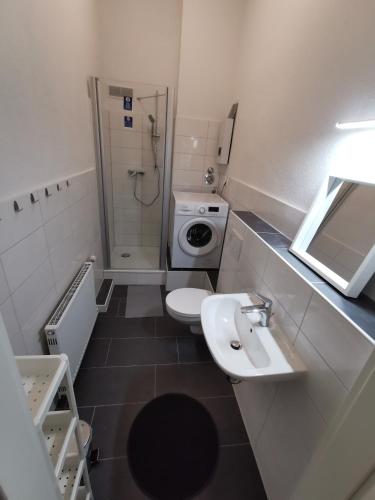 a bathroom with a sink and a toilet and a shower at Modern Apartment Hagen - Dortmund in Hagen