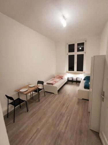 a room with a bed and a table and chairs at Modern Apartment Hagen - Dortmund in Hagen