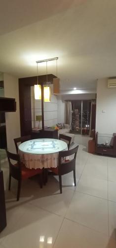 a room with a table and chairs and a living room at Apartemen Thamrin City 2 BIG BR,85sqm,City View in Jakarta