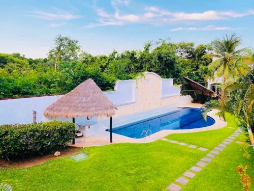 an external view of a villa with a swimming pool at Dolce Vita Caribe Villas in Playa del Carmen