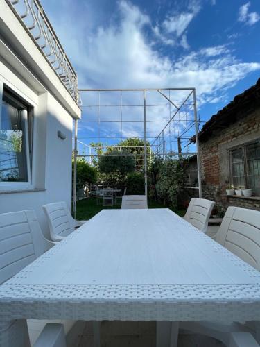 a white table and chairs on a patio at Vila Nela in Shkodër