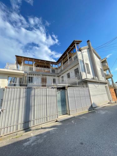 a white house with a fence in front of it at Vila Nela in Shkodër