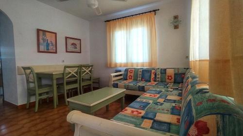 a living room with a couch and a table at Son Bou Bonito y renovado Apartamento in Alaior
