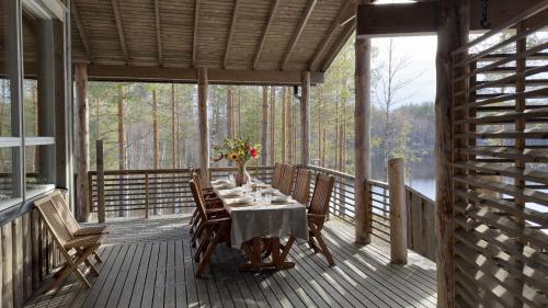 a table on the deck of a cabin at Villa Kolovesi - Saimaa Retreat in Savonlinna