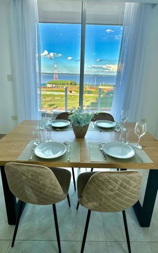 a wooden table with chairs around it with a view at Rio Suits Apartments A in Posadas