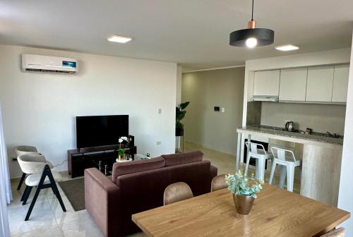 a living room with a couch and a table at Rio Suits Apartments A in Posadas