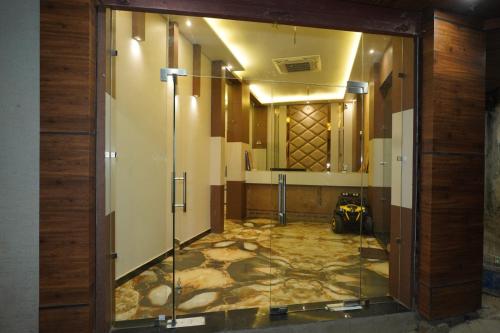 a hallway with a glass door in a building at HOTEL GANDHI in Alwar