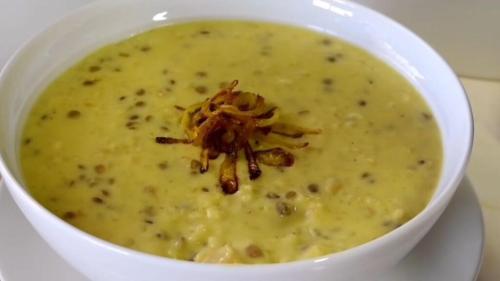 a white bowl of soup with apillar on it at look house in Amman