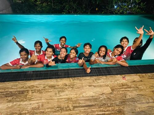 um grupo de crianças posando para uma foto em uma piscina em Thalangama Lakeview Lodge em Battaramulla