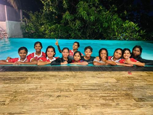 a group of people sitting in a swimming pool at Thalangama Lakeview Lodge in Battaramulla