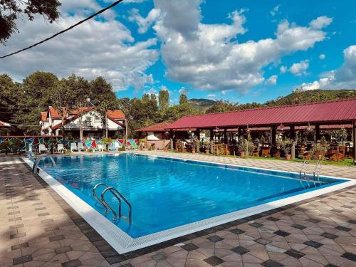 une piscine dans un complexe avec un bâtiment en arrière-plan dans l'établissement Villa Tino Omorani, à Veles