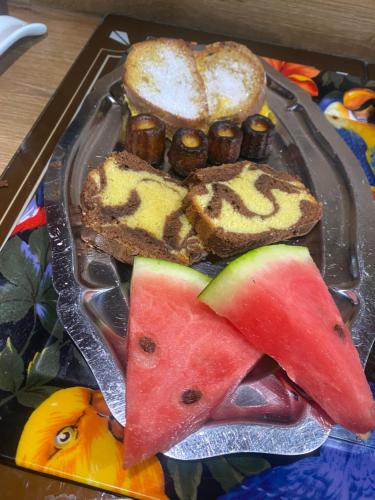 a tray of food with bread and fruit on it at Les Chambres des 3 Chouettes in Sepx