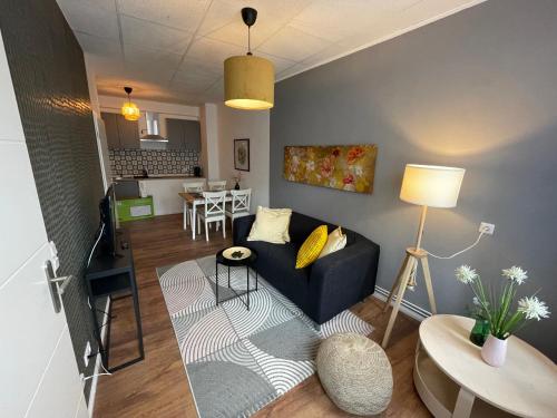 a living room with a couch and a table at Modernes Appartement "Ilse" in Bitterfeld Goitzsche in Bitterfeld