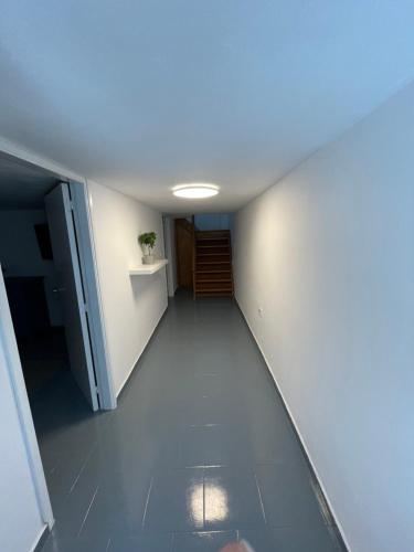 an empty hallway with a hallway leading to a door at Spanos Suites - Panteli in Panteli