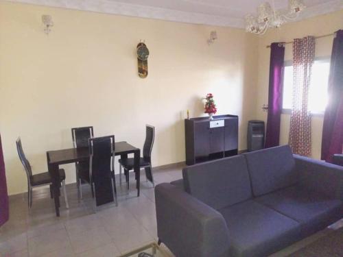 a living room with a couch and a table at Comfort Zone Apartment in Yaoundé