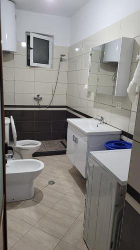 a bathroom with a toilet and a sink at Brayan guest house in Pogradec