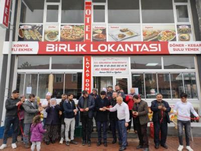 a group of people standing in front of a restaurant at Çiftlik otel 
