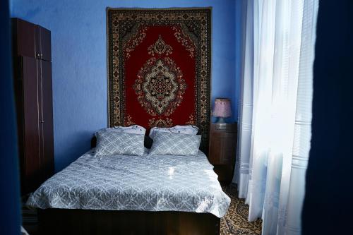 a bedroom with a bed with a red wall at Casa familiei Iarmurati in Pohrebea